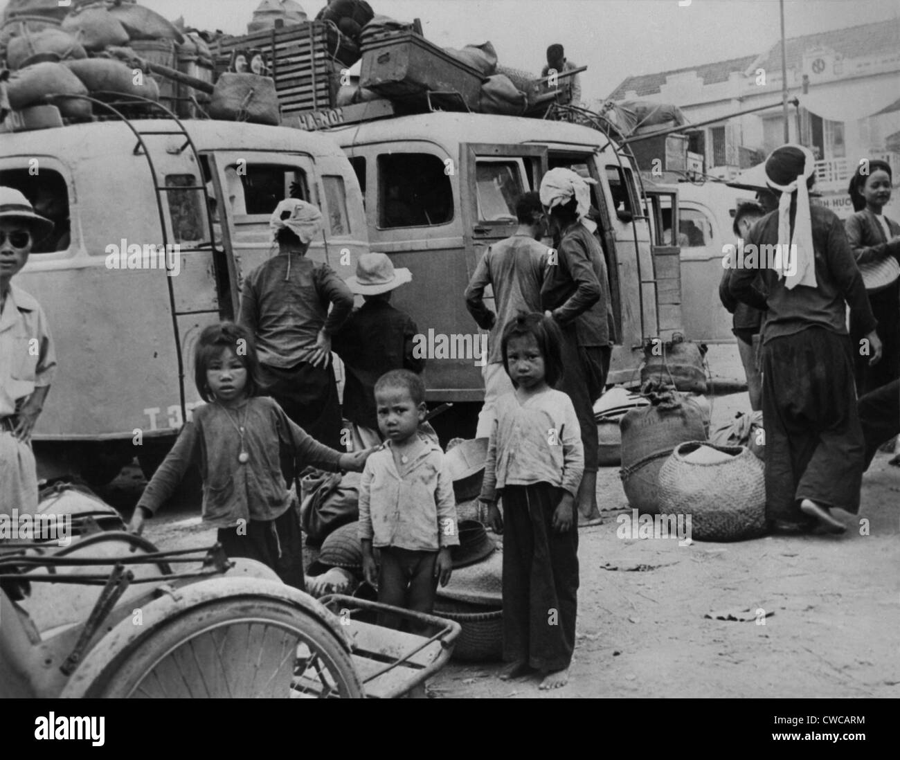 Children and adults evacuating from Nam-Dinh, North Vietnam. An estimated 750,000 northerners, mostly Catholics, fled to South Stock Photo