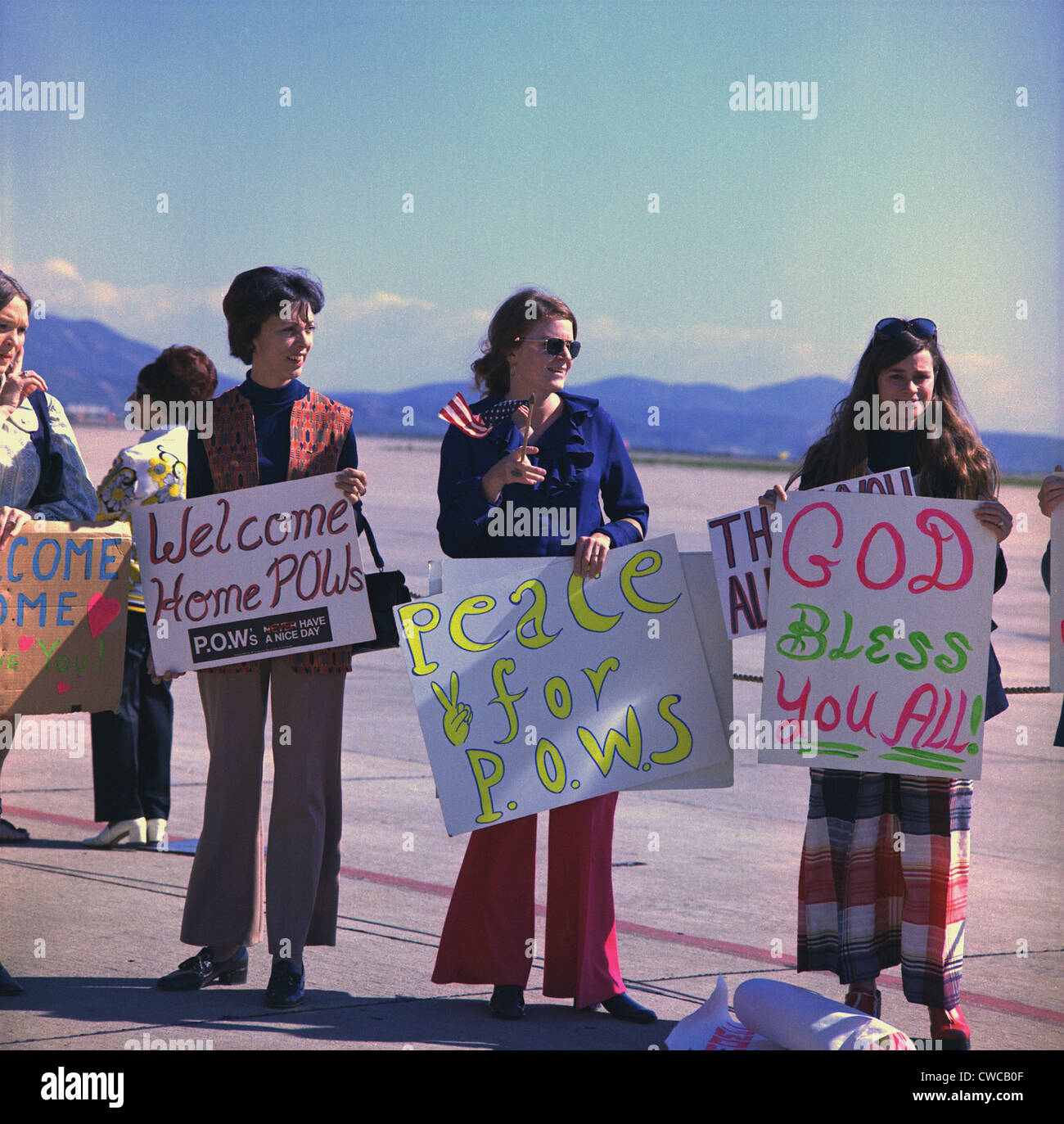 Wives welcome home US Marine POWs. Marine wives wait with signs for their husbands who were released in Hanoi, North Vietnam, Stock Photo