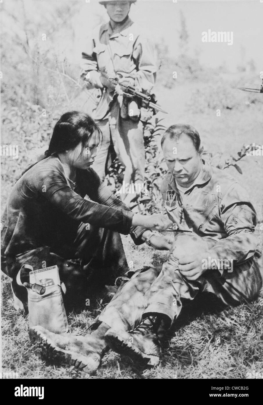US Air Force Captain Wilmer Newk Grubb is given first aid by his captors in North Vietnam. He was taken prisoner after ejecting Stock Photo