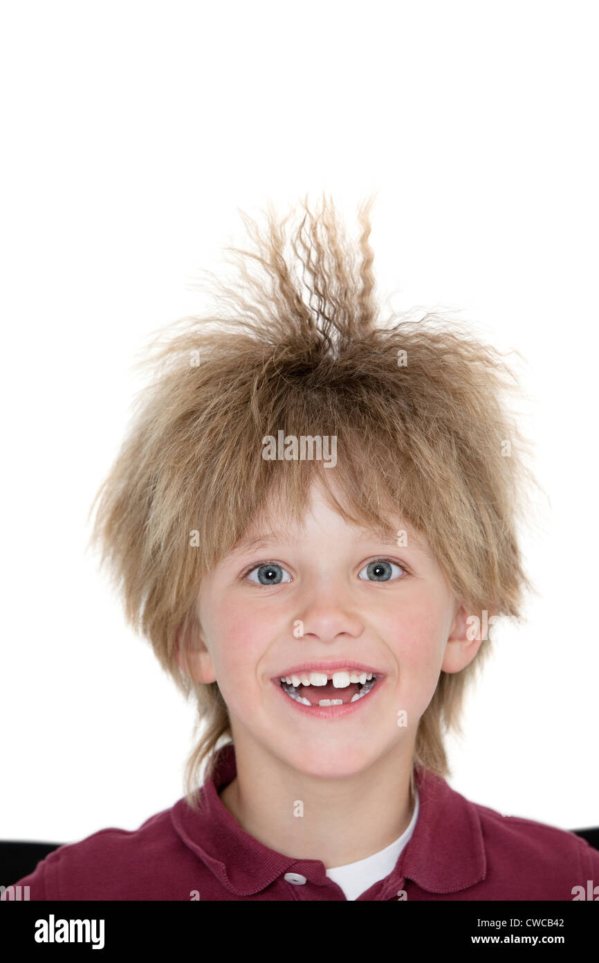 Close-up portrait of a cheerful school boy with spiked hair over colored background Stock Photo