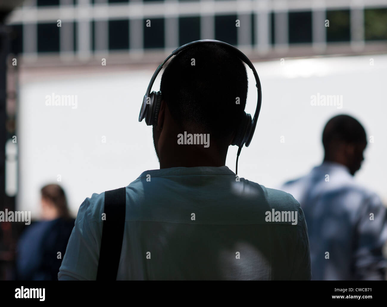 A park visitor wears his Beats by Dr. Dre headphones in Bryant Park in New York Stock Photo