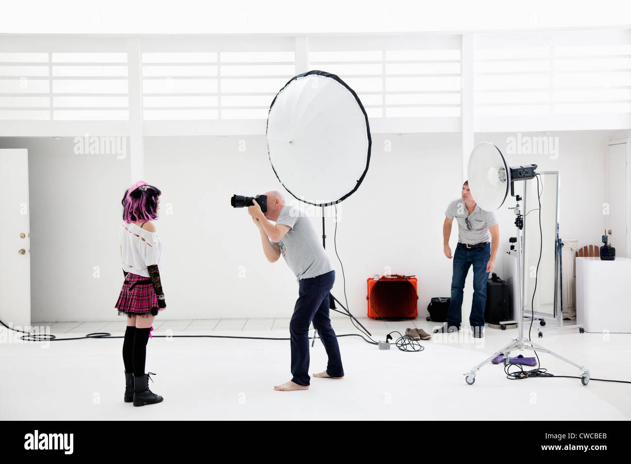 Photographer shooting fashion model in photo shoot Stock Photo