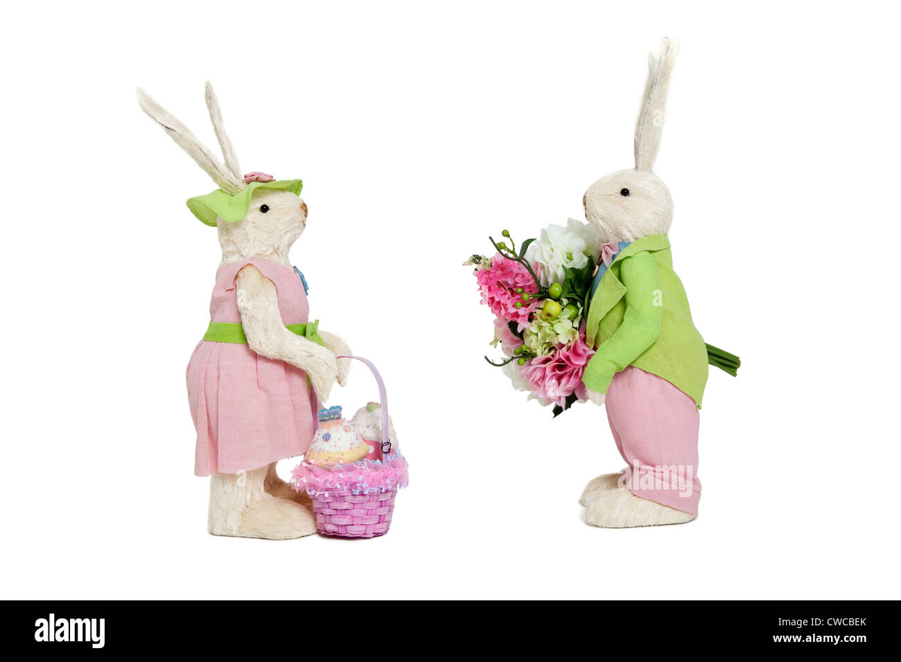 Stuffed toys portrayed as male with flowers and female with basket over white background Stock Photo