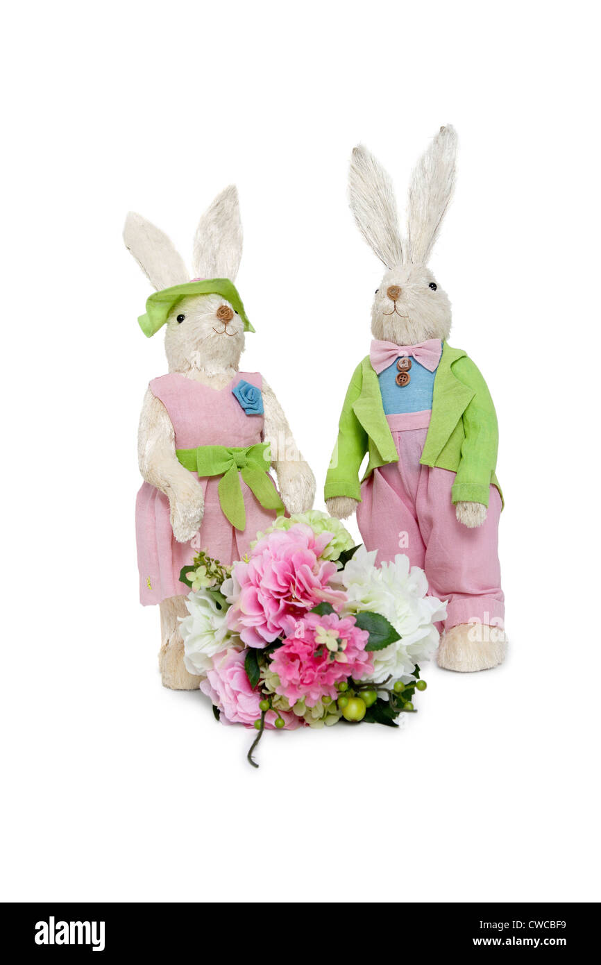 Portrait of stuffed Rabbit couple standing together with flower bouquet over white background Stock Photo