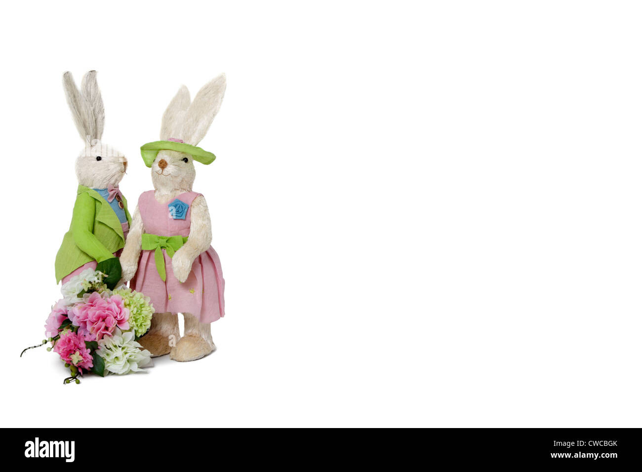 Rabbit couple with flower bouquet standing over white background Stock Photo