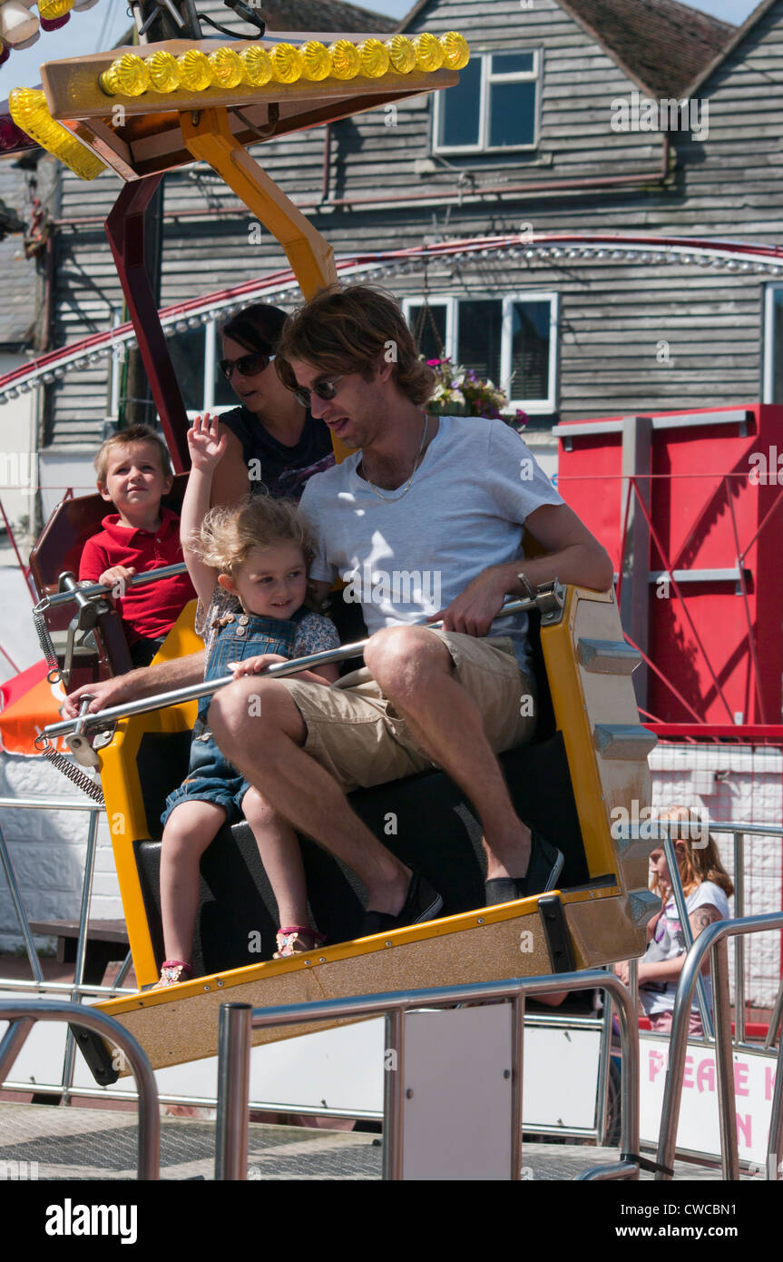 Father and Daughter On A Fairground Ride UK Fairgrounds Funfairs Rides Stock Photo