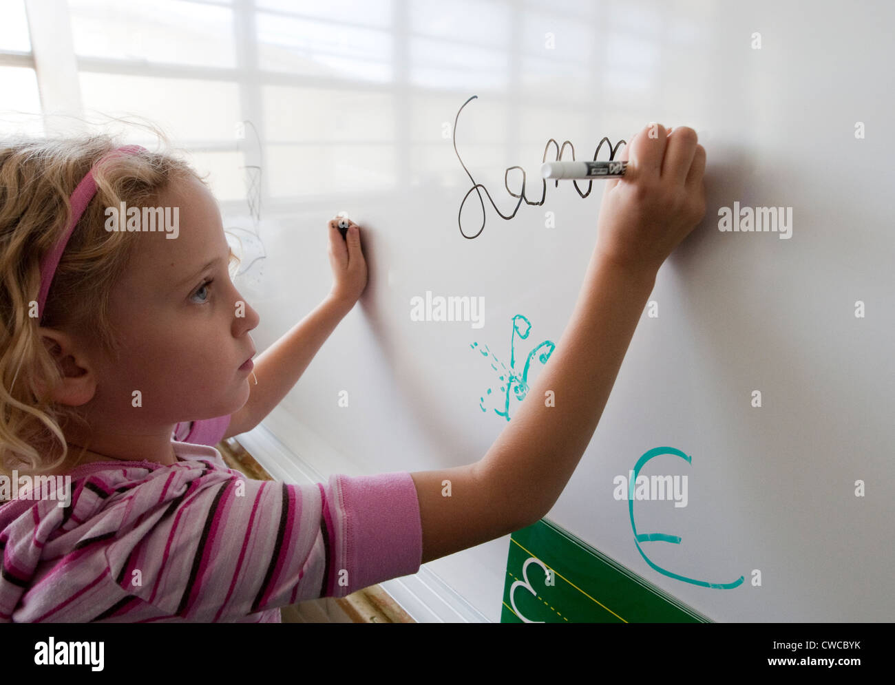 child writing on whiteboard