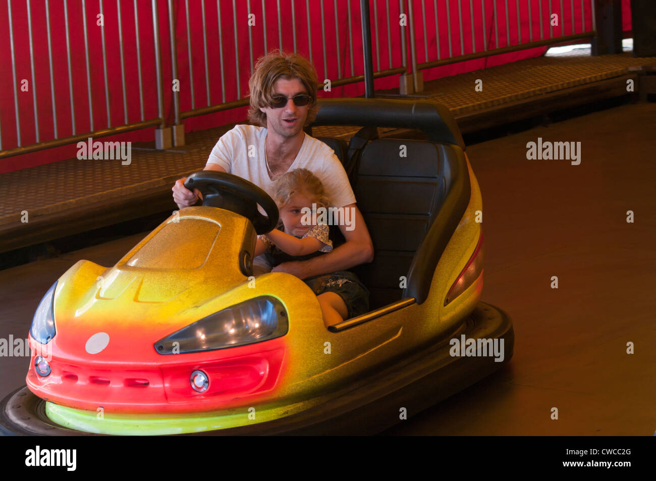 Father and Daughter On A Fairground Bumper Car UK Fairgrounds Funfairs