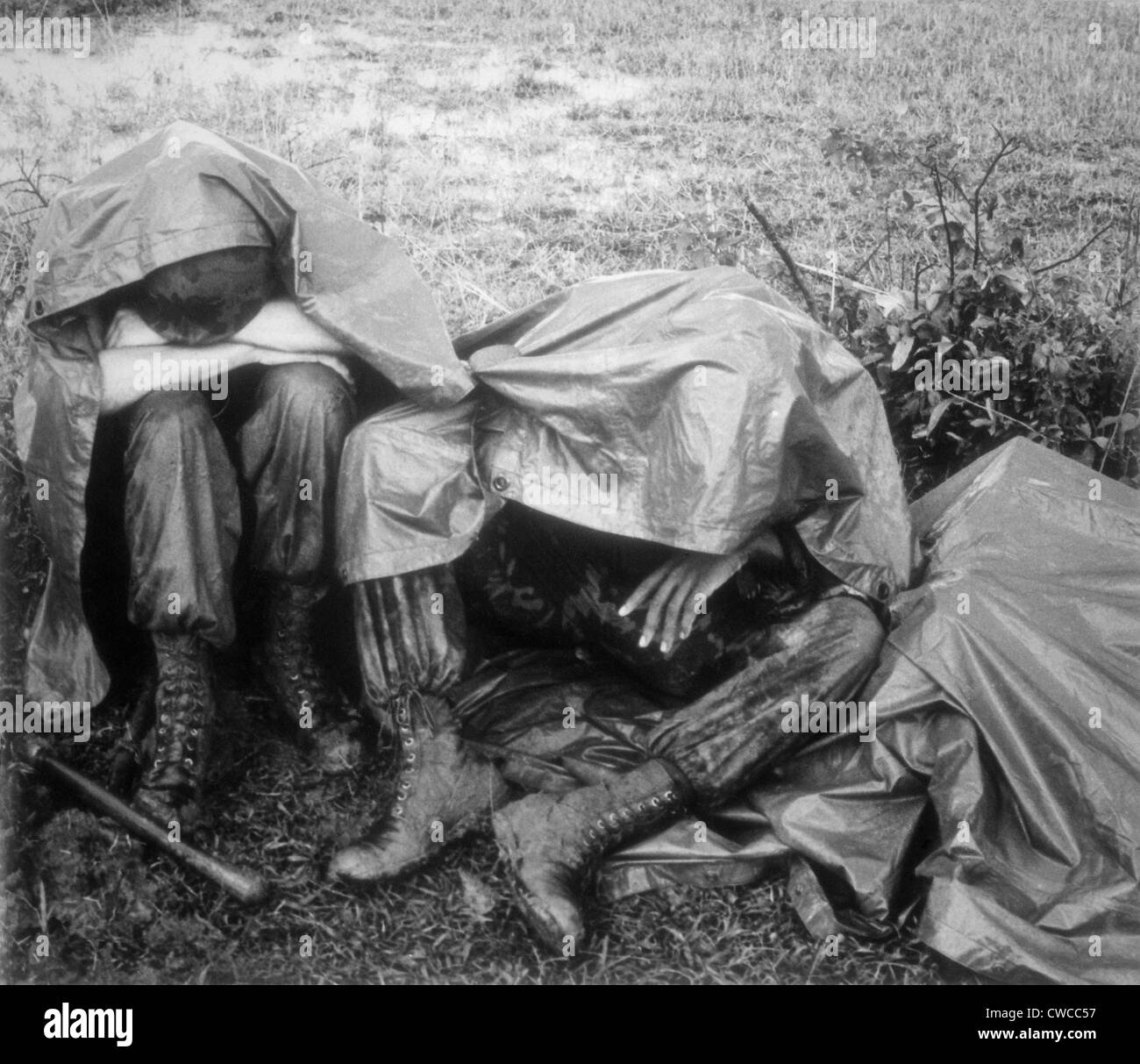 Vietnam War. Two battle weary US Marines take a break, rain and all, during Operation Bold Mariner. The operation's mission was Stock Photo