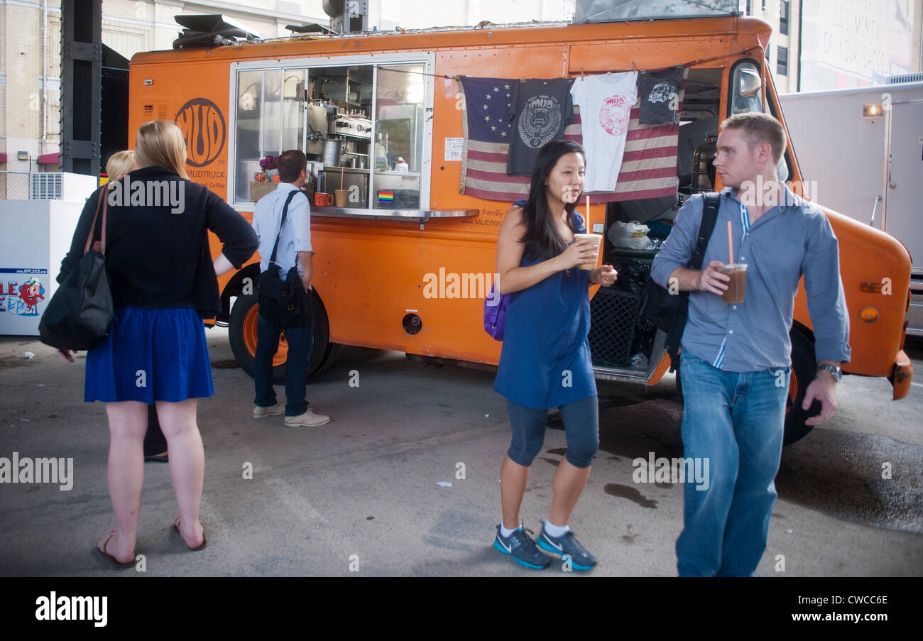 Visitors line up for free iced coffee from the Mud Truck parked under the High line in Chelsea in New York Stock Photo