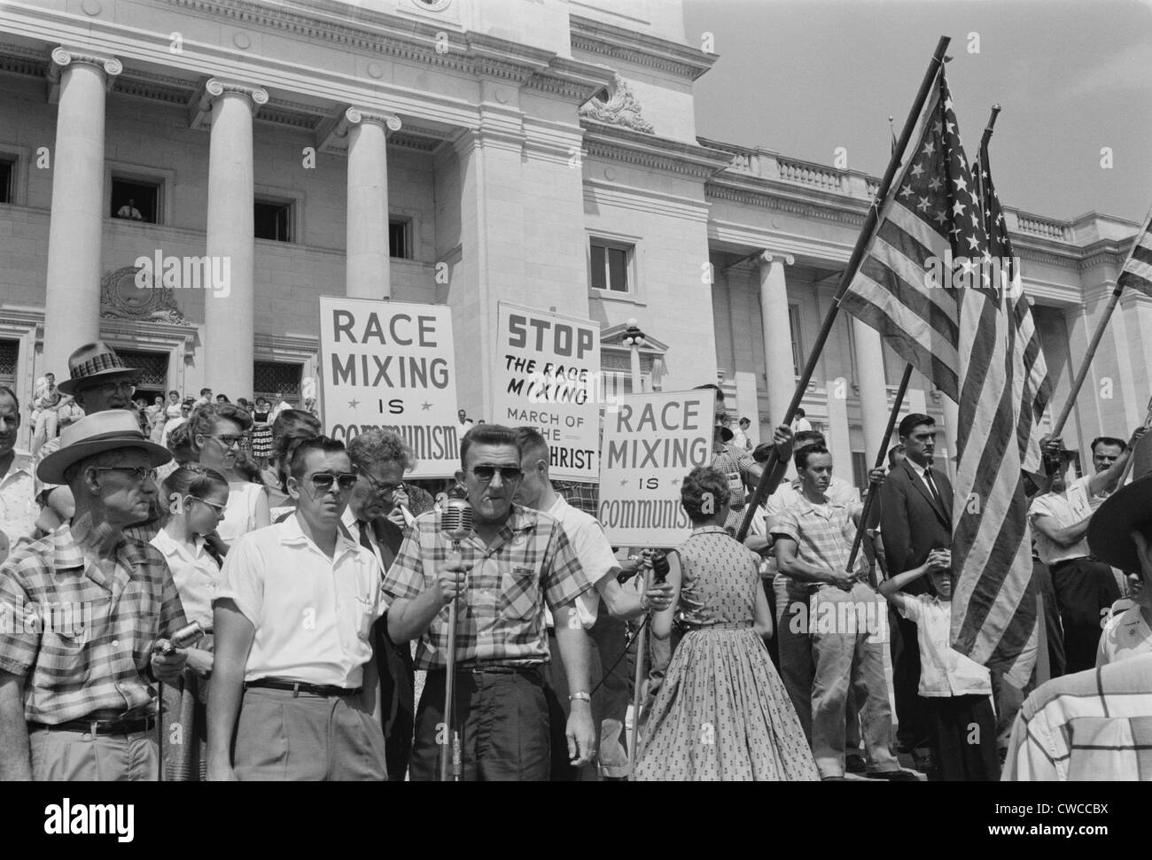 Segregationist rally in Little Rock. Whites holding signs protesting against 'Communist race-mixing' on the steps of the State Stock Photo