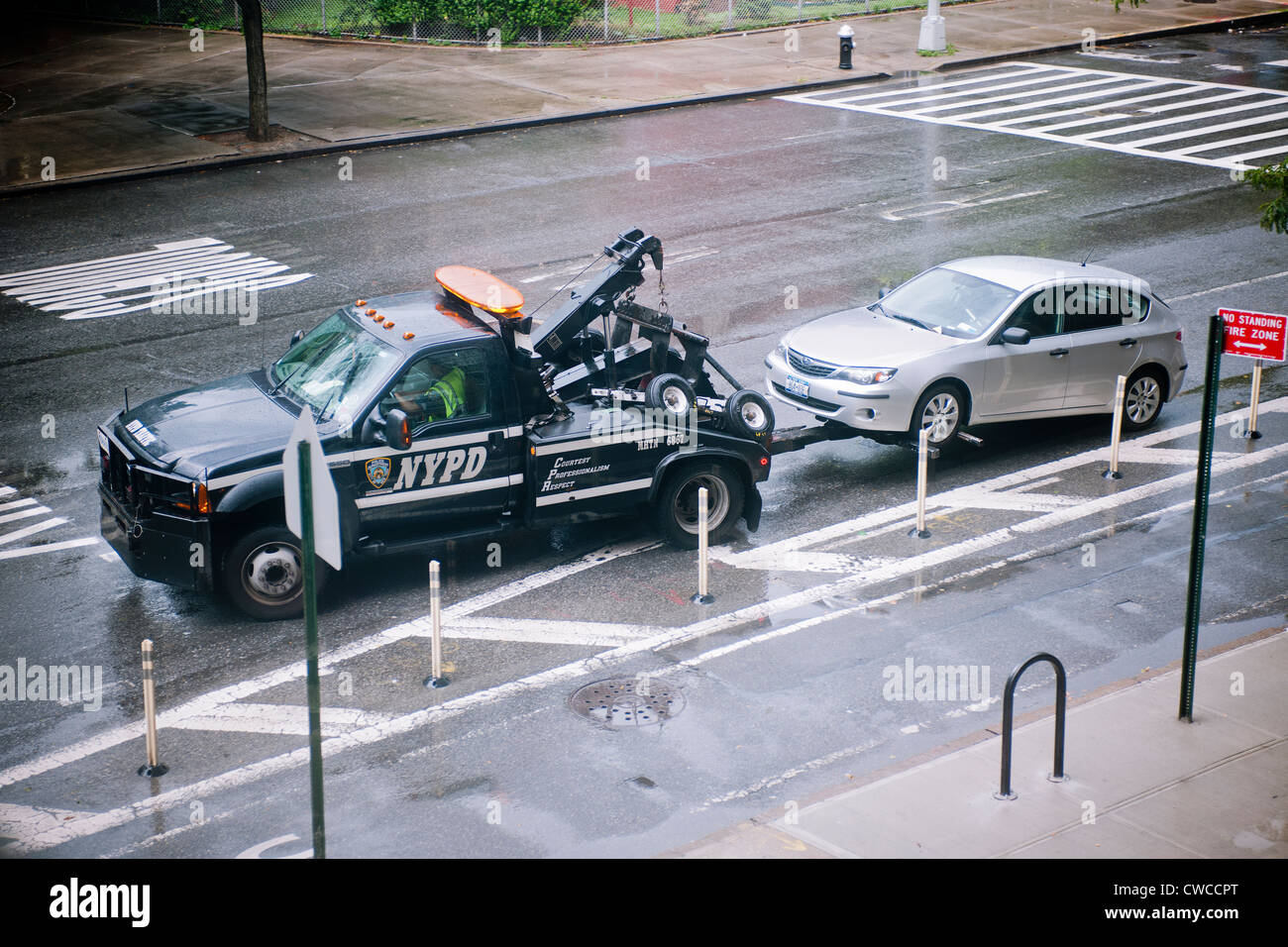 A driver gets their car towed from a "No Parking" zone in the Chelsea