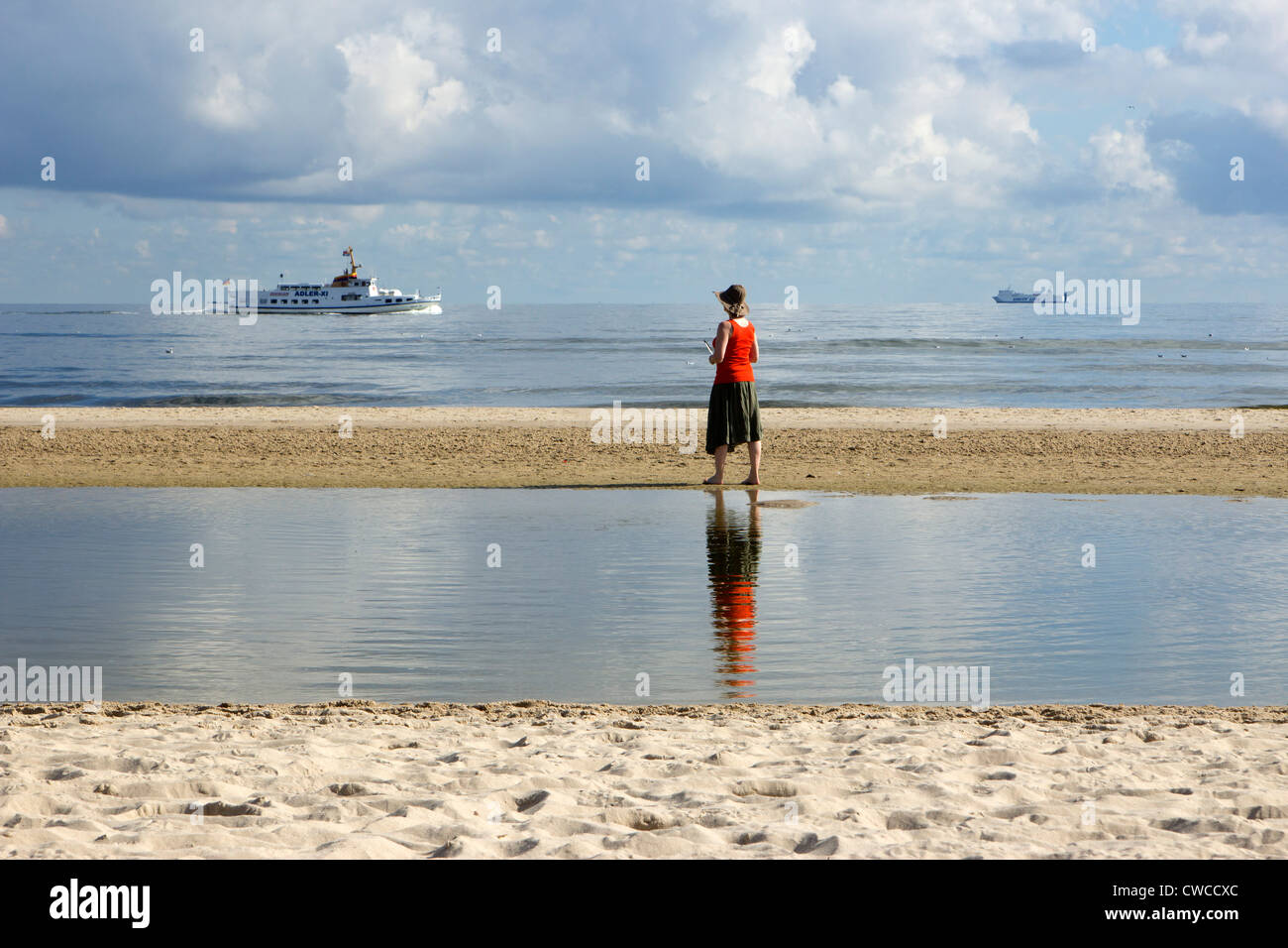 woman standing at the beach of Heringsdorf, Usedom Island, Baltic Sea Coast, Mecklenburg-West Pomerania, Germany Stock Photo