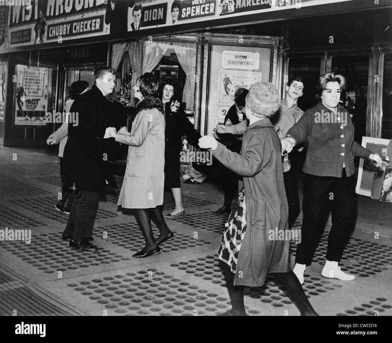 Teens dancing the 'Twist' outside the Brooklyn Fox Theatre before the premiere of the movie 'Twist Around the Clock'. 1961. Stock Photo