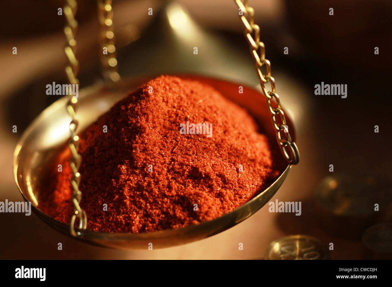 Cayenne pepper in weighing scales Stock Photo