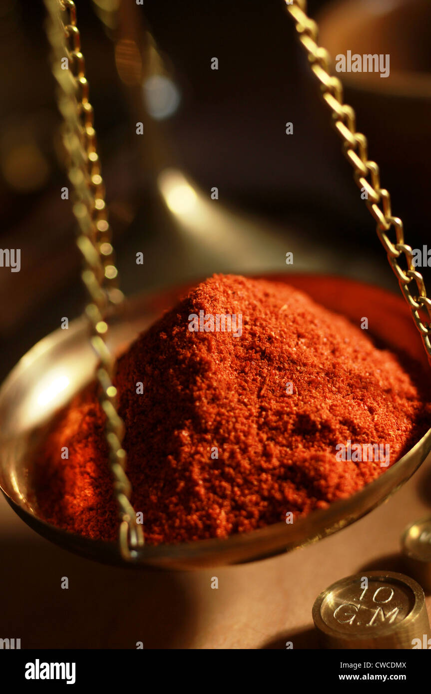 Cayenne pepper in weighing scales Stock Photo