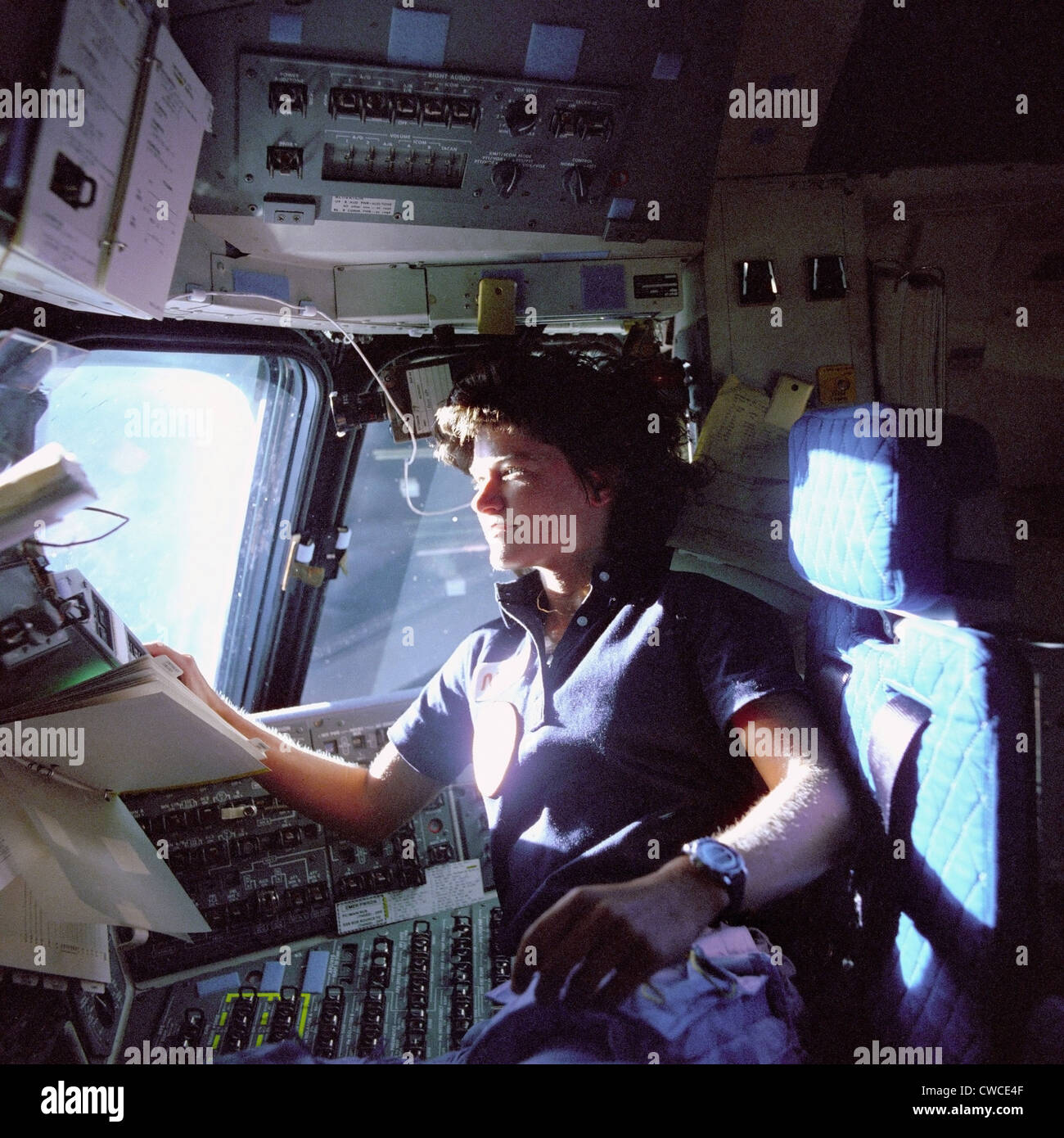 Astronaut Sally Ride monitors control panels from the pilot's chair on the flight deck of the Space Shuttle Challenger. She Stock Photo