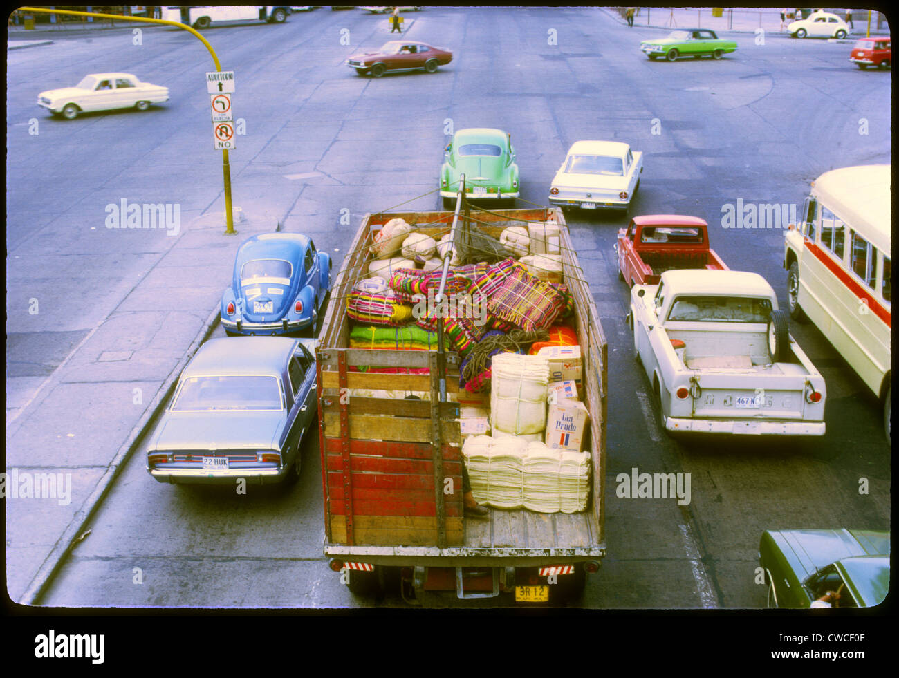 truck in parking lot loaded with hand made blankets and other goods guadalajara, mexico 1973 colorful city scape traffice VWs ca Stock Photo