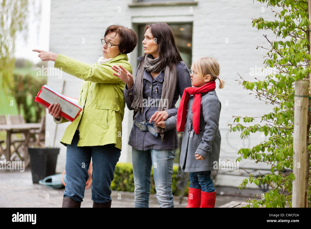 Real estate agent showing woman a house Stock Photo - Alamy