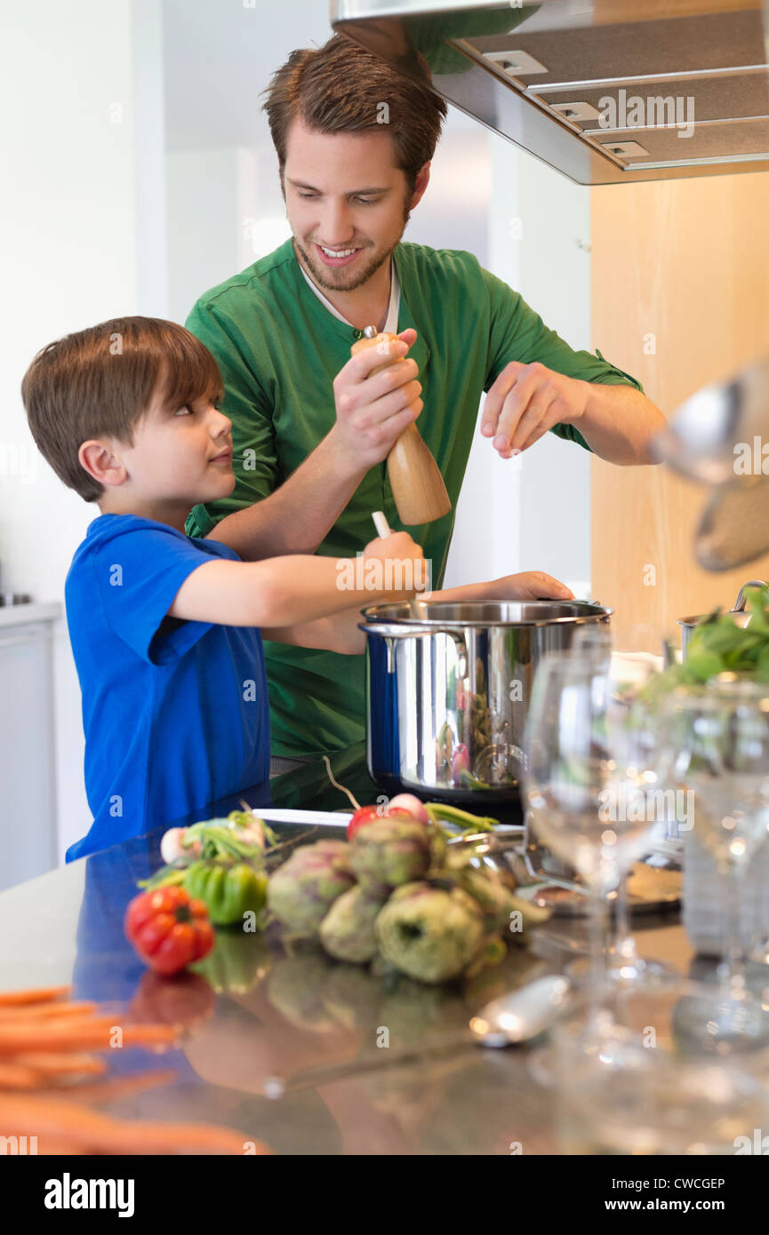Boy assisting his father in the kitchen Stock Photo - Alamy