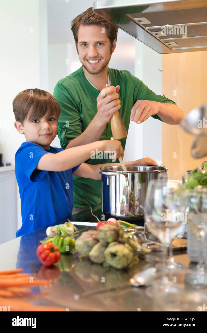 Boy assisting his father in the kitchen Stock Photo - Alamy