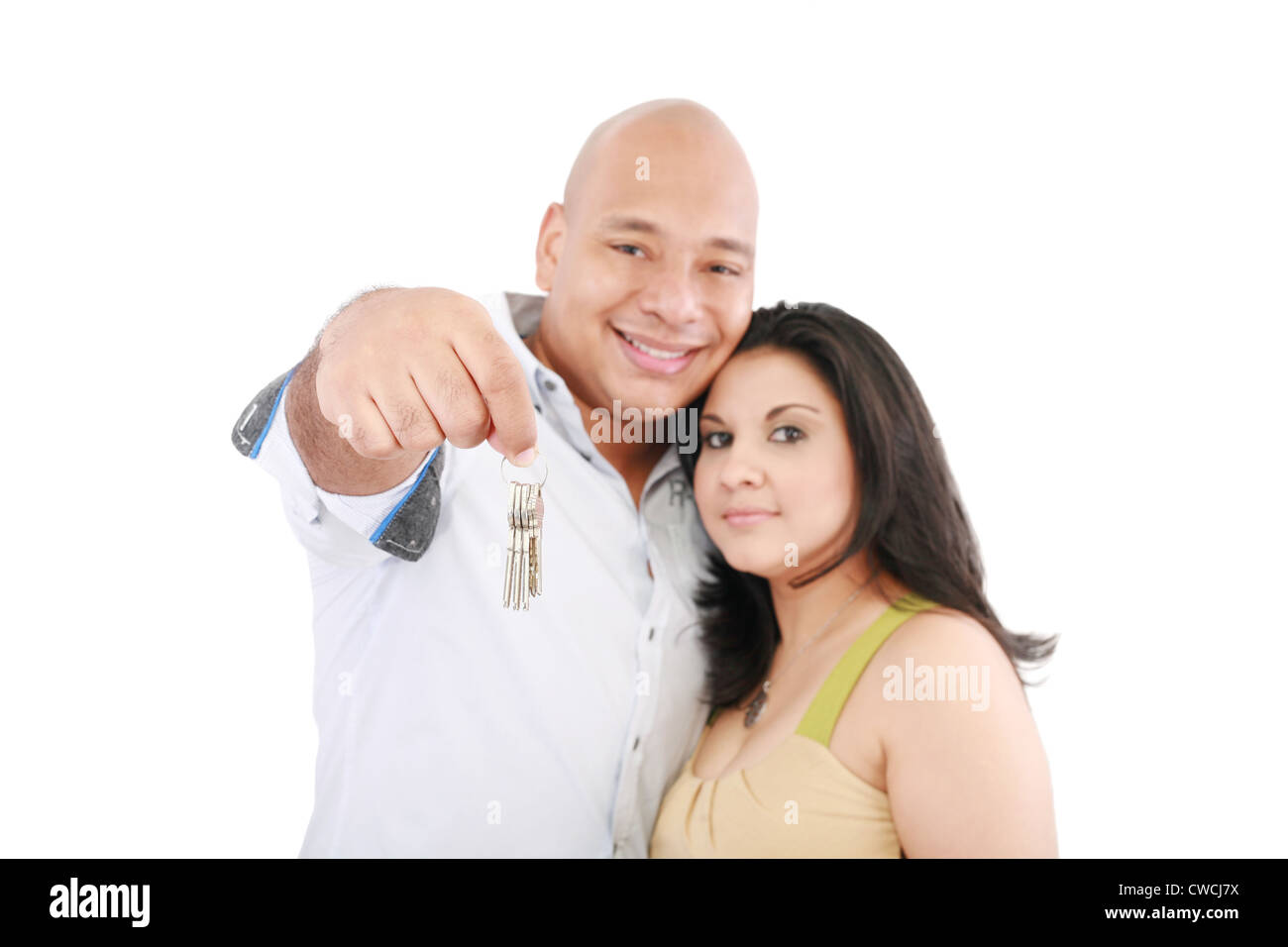 Young smiling couple holding keys of their new house Stock Photo - Alamy