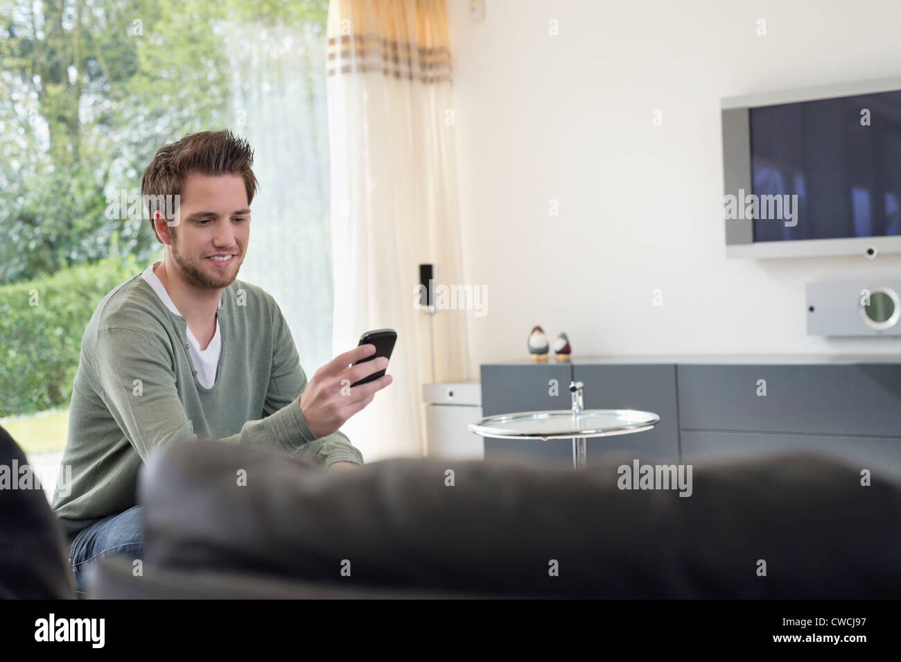 Man reading a text message on mobile phone Stock Photo