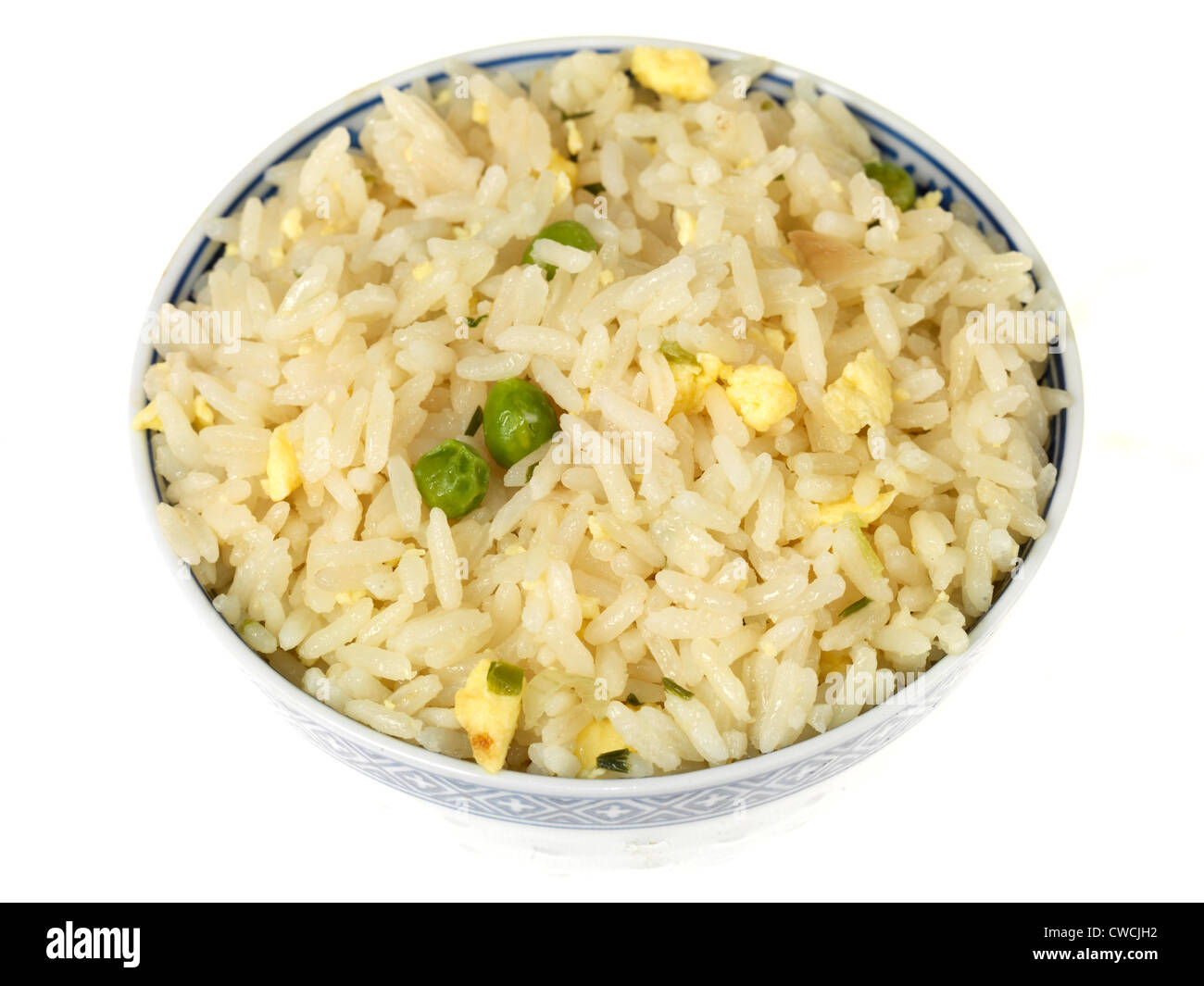 Freshly Cooked Bowl Of Chinese Or Asian Style Egg Fried Rice With Green Peas, Isolated Against A White Background, With A Clipping Path And No People Stock Photo
