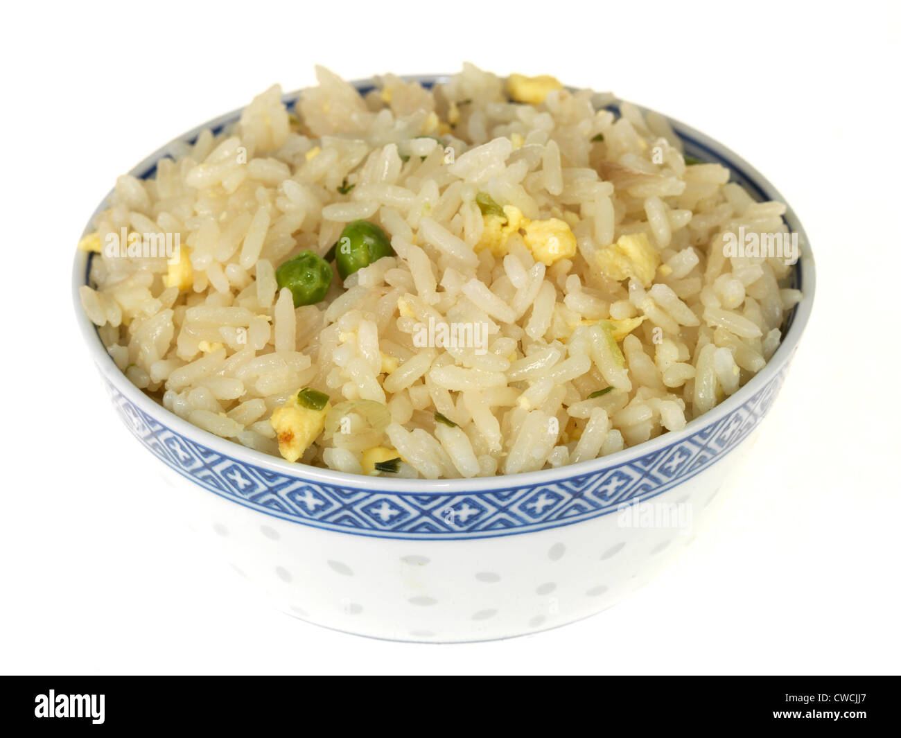 Freshly Cooked Bowl Of Chinese Or Asian Style Egg Fried Rice With Green Peas, Isolated Against A White Background, With A Clipping Path And No People Stock Photo