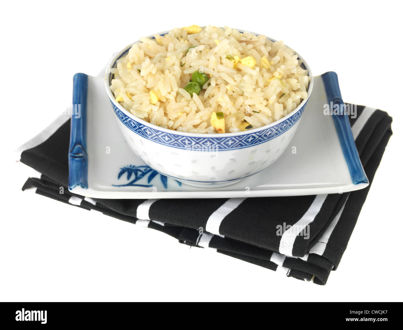 Freshly Cooked Bowl Of Chinese Or Asian Style Egg Fried Rice With Green Peas, Isolated Against A White Background, With A Clipping Path And No People Stock Photo