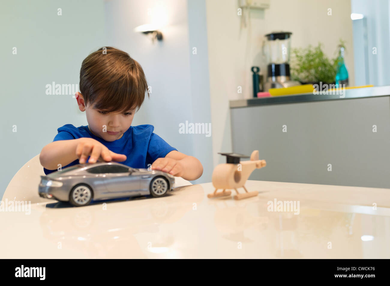 Boy playing with a toy car Stock Photo - Alamy