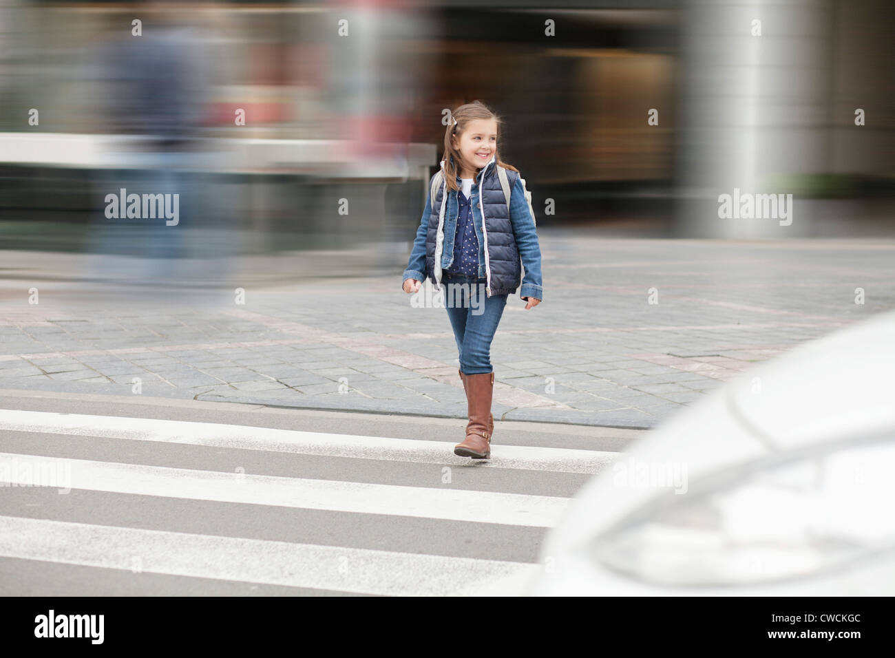 Schoolgirl crossing a road Stock Photo - Alamy