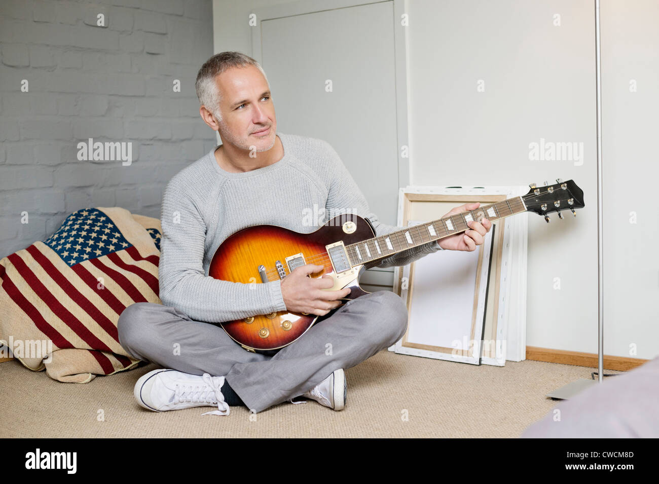 Man playing a guitar at home Stock Photo - Alamy