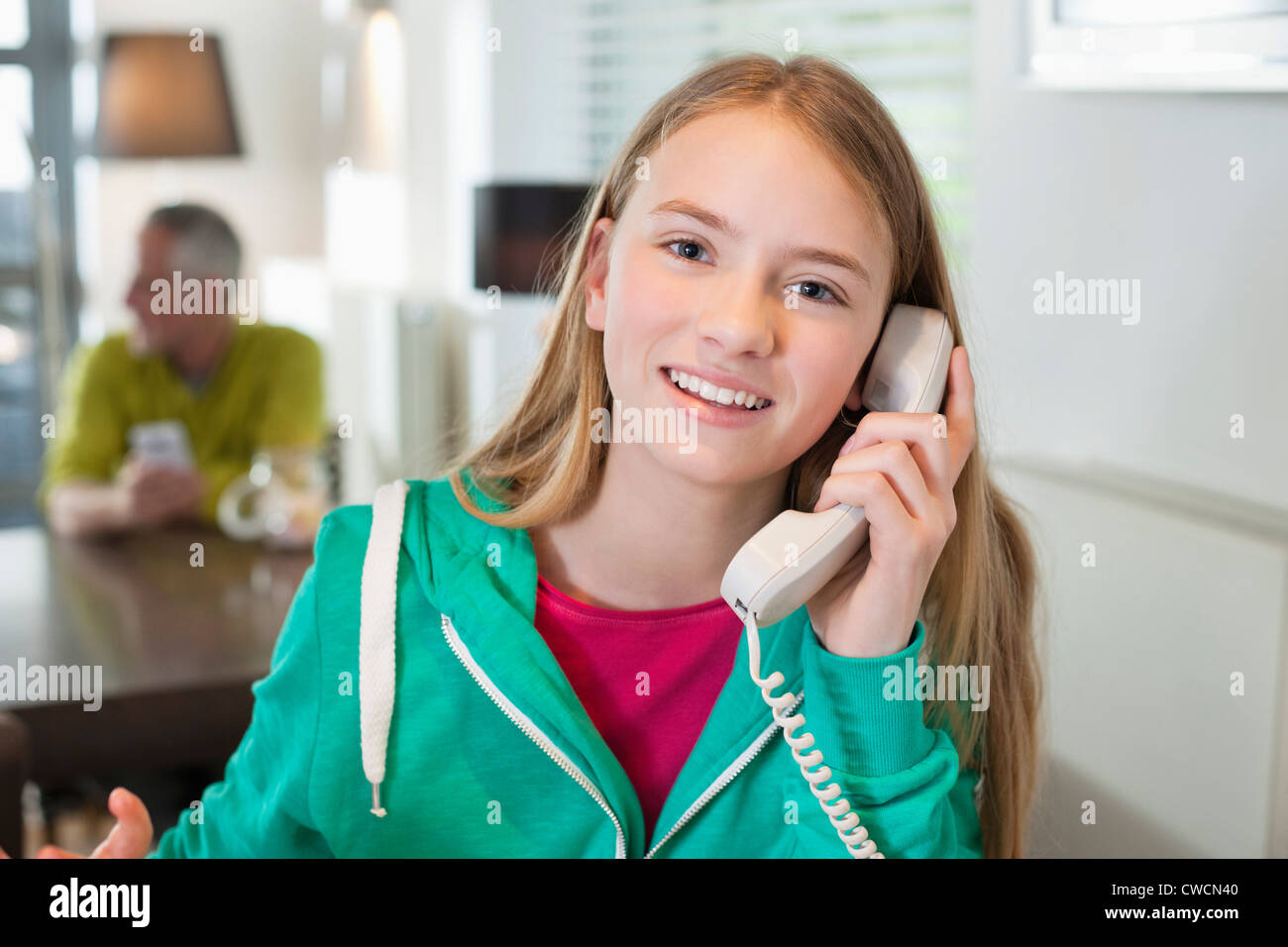 Portrait of a girl talking on a phone and smiling Stock Photo - Alamy