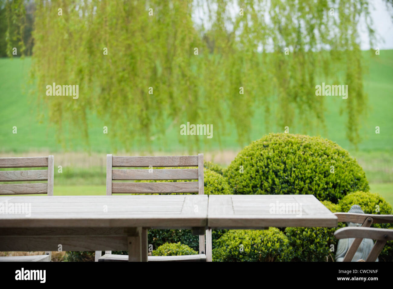 Table with chairs in a garden Stock Photo - Alamy