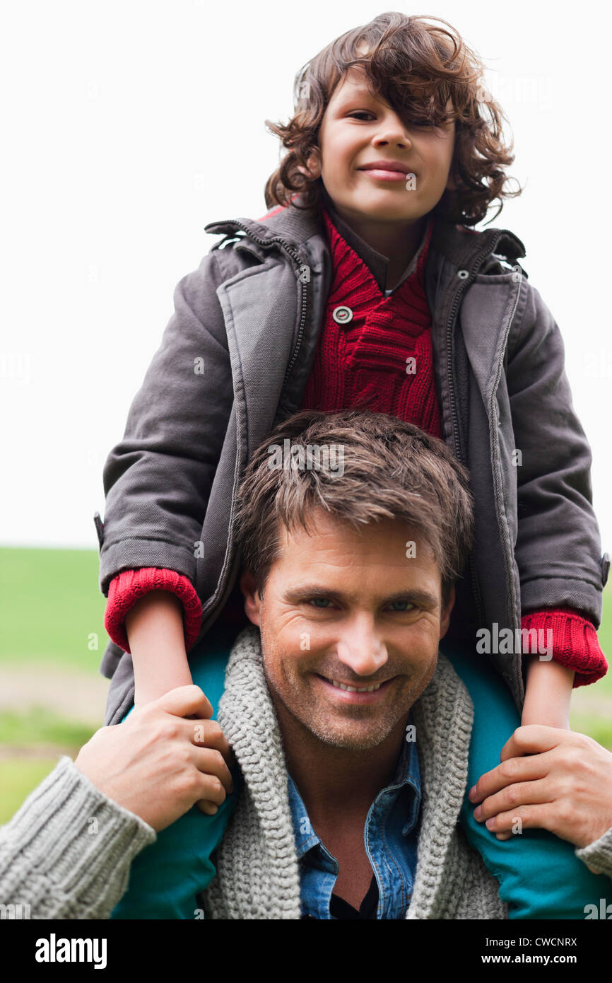Man carrying his son on shoulders Stock Photo - Alamy