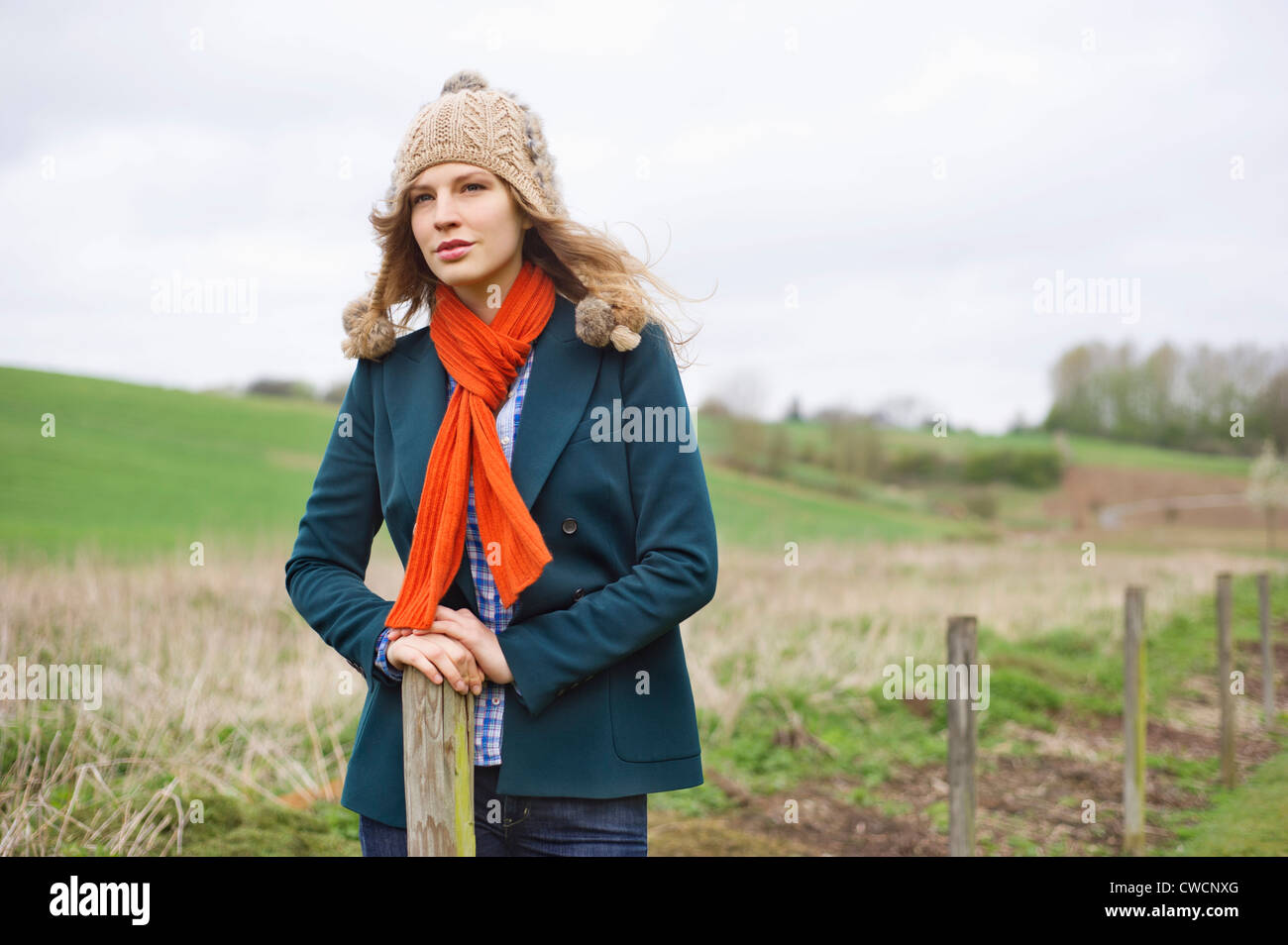 Beautiful woman standing in a field Stock Photo - Alamy