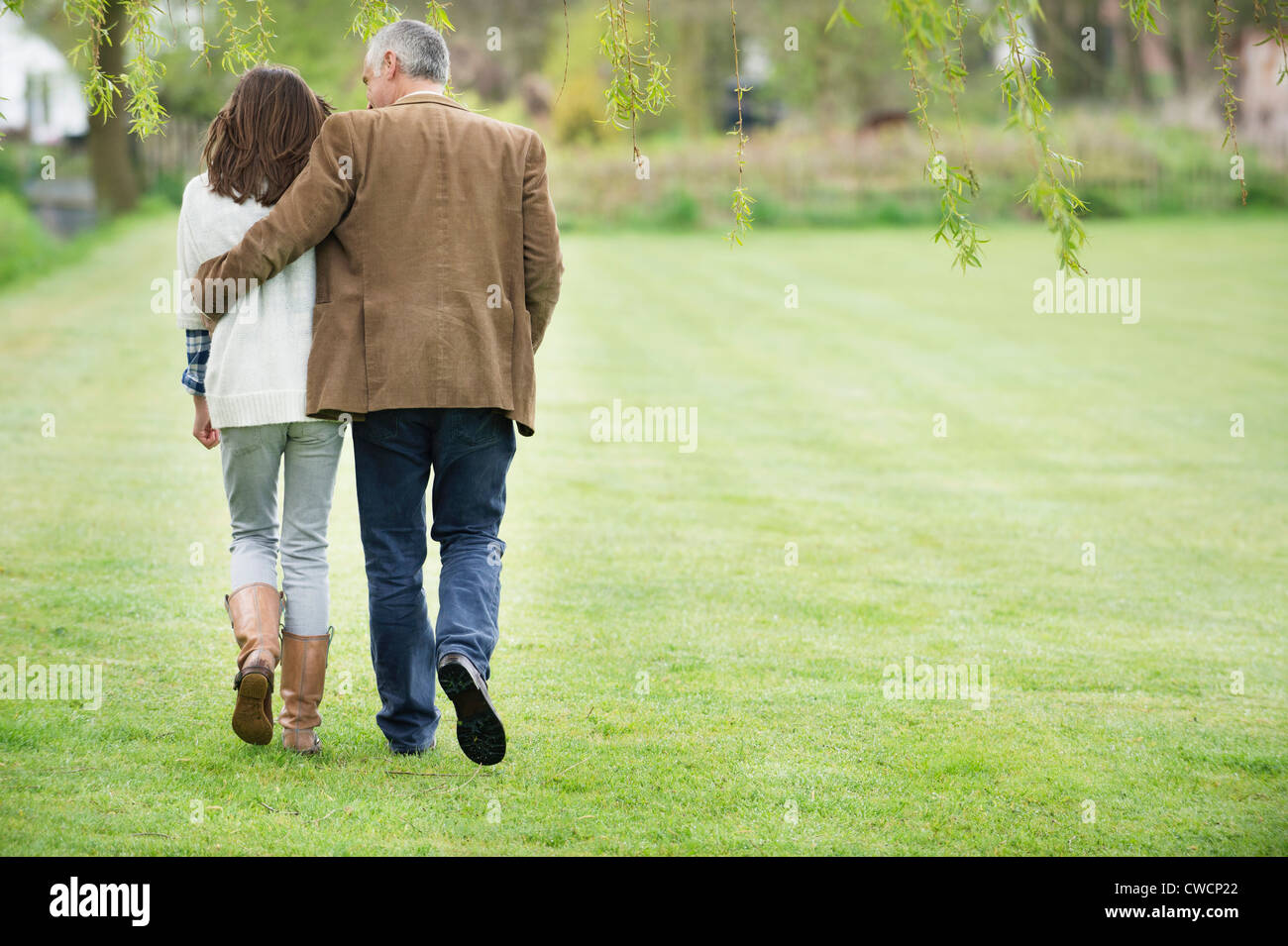 Man walking with his daughter in a park Stock Photo - Alamy