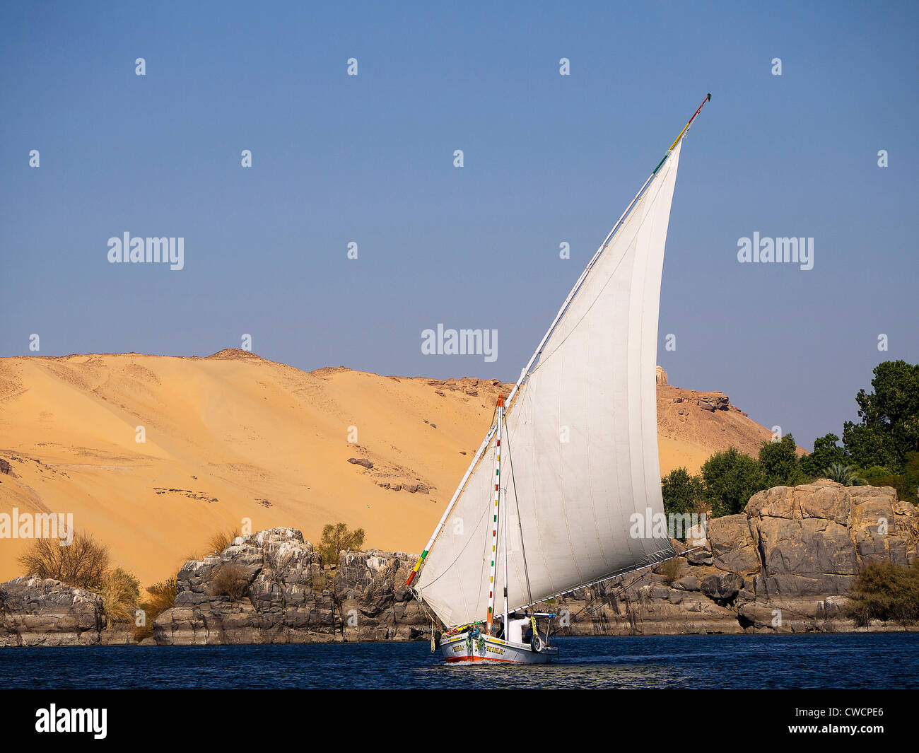 Feluccas on the River Nile near to Aswan in Egypt. Feluccas are the ...