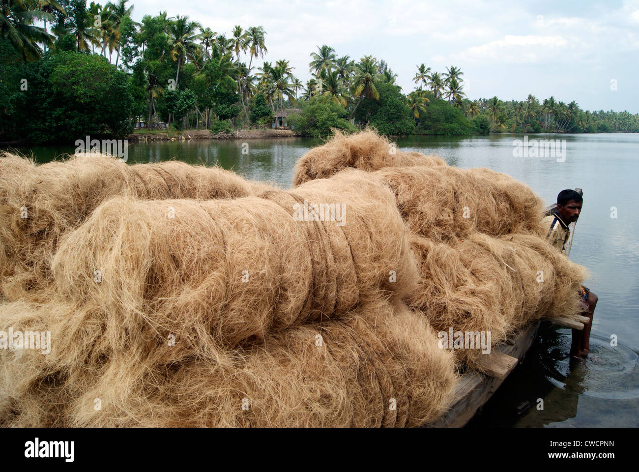 Raw Materials of Coir Products transported from Small scale Coir industries through Kerala Backwaters by Wooden Canoe Boats Stock Photo