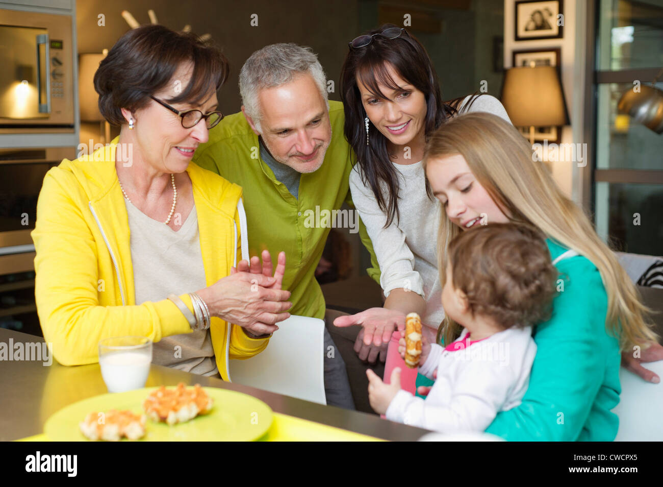 Happy family at the breakfast table Stock Photo - Alamy
