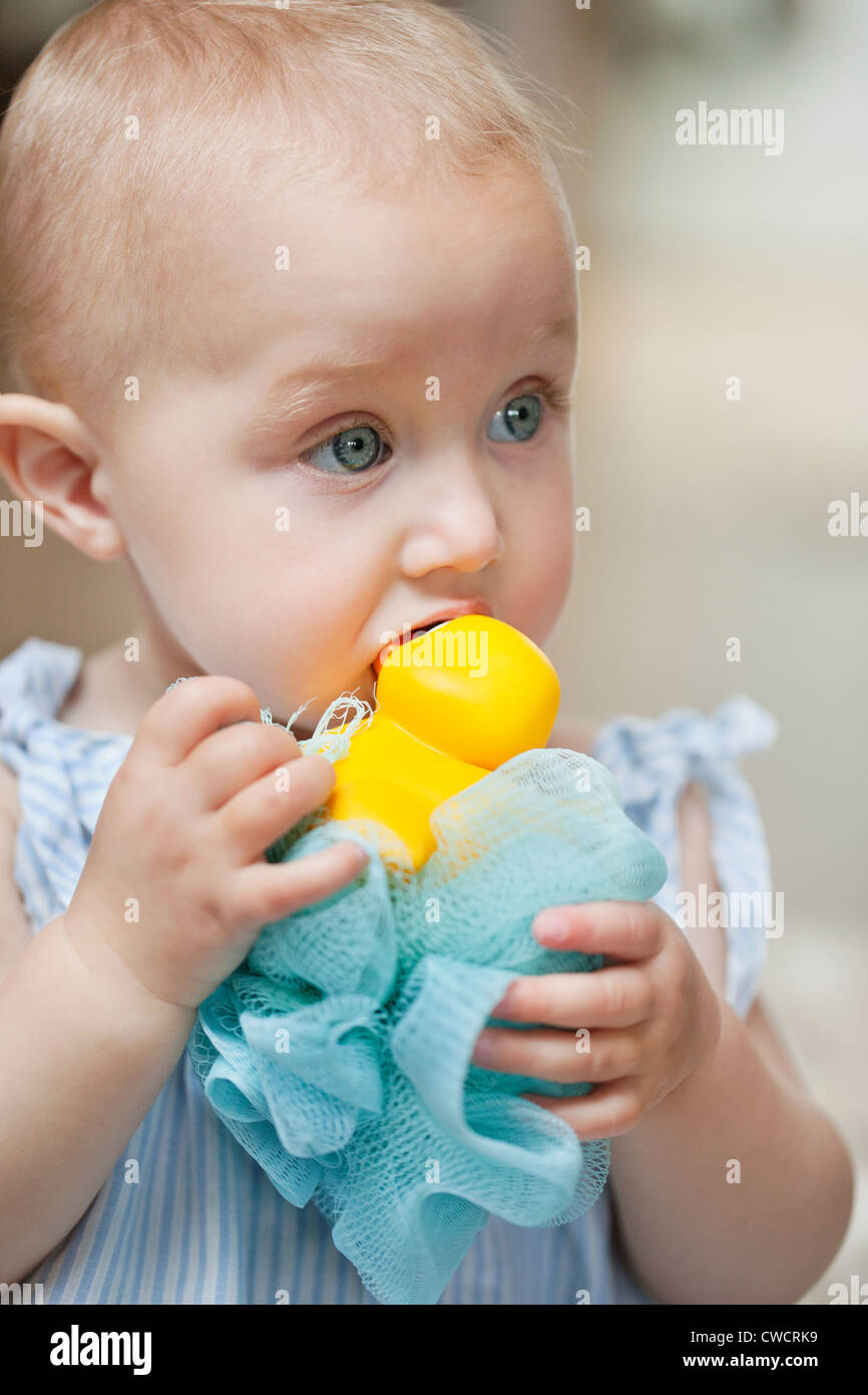 Close-up of a baby girl playing with a toy Stock Photo - Alamy