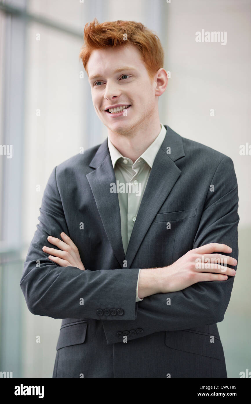 Close-up of a businessman smiling with his arms crossed in an office ...