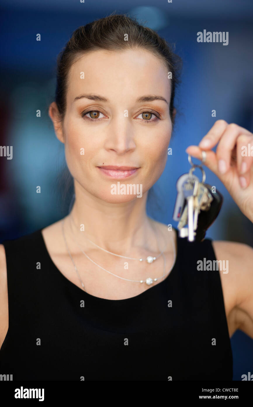 Portrait of a businesswoman holding keys Stock Photo - Alamy