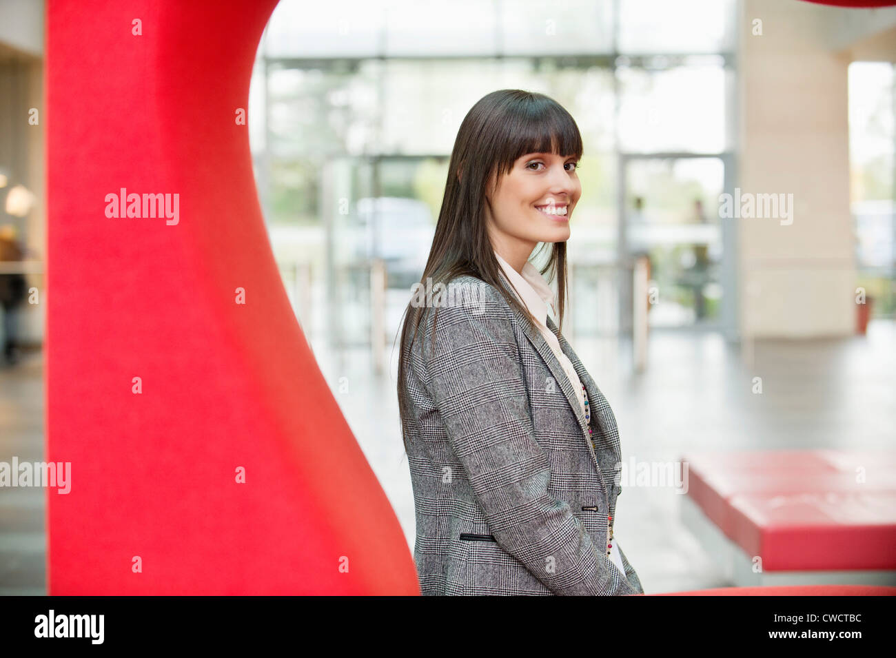 Portrait of a businesswoman smiling in an office Stock Photo - Alamy