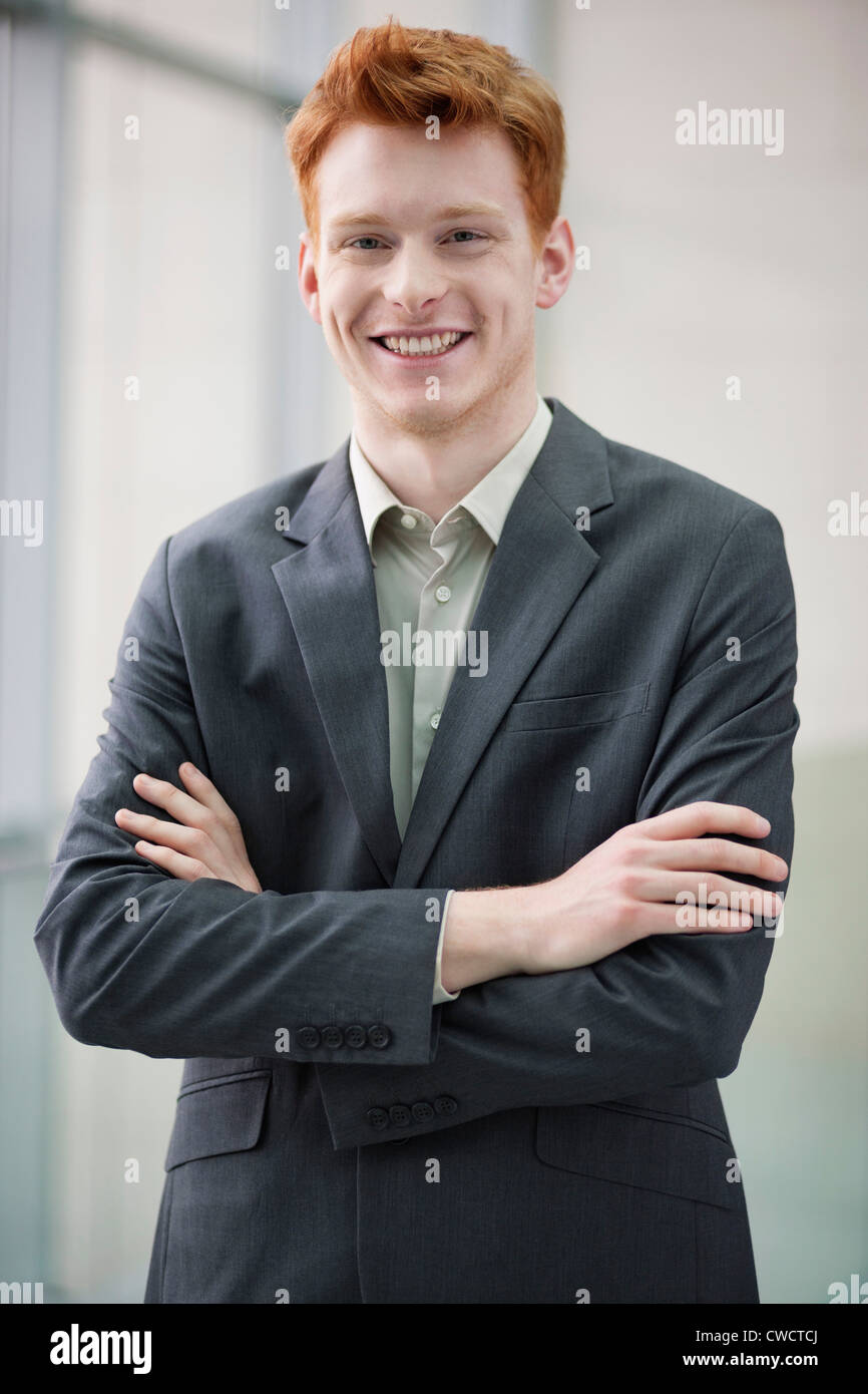 Portrait of a businessman smiling with arms crossed Stock Photo - Alamy