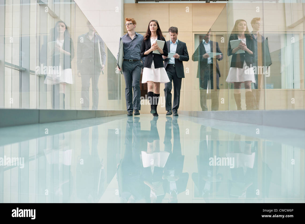Business executives walking in a corridor Stock Photo - Alamy