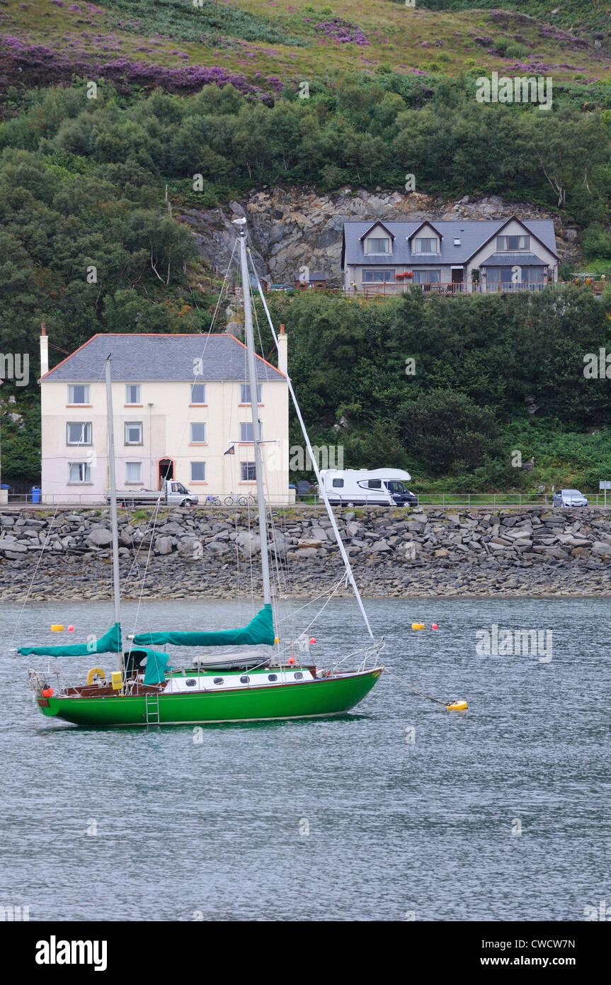 Green yacht moored off the Mallaig coastline, Scotland, UK Stock Photo