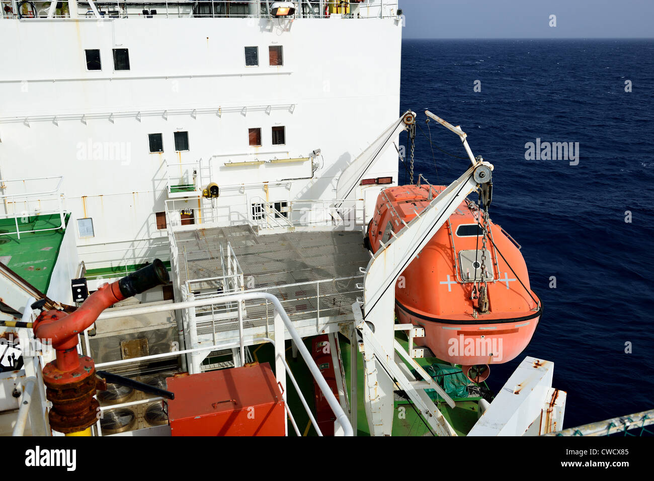 Evacuation boat is hang on the oil rig. Stock Photo