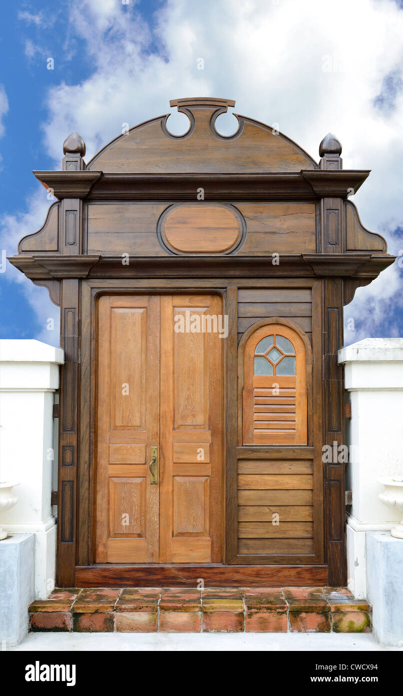The retro wooden door on the blue sky background. Stock Photo